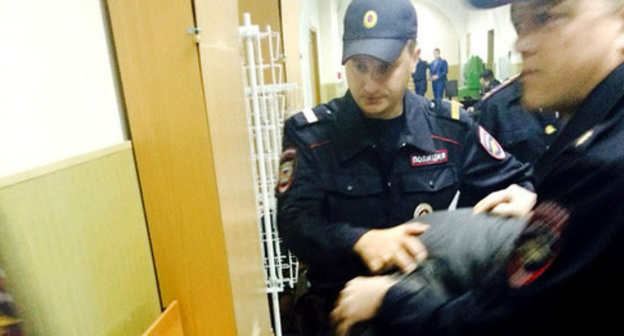 Law enforcers lead one of the defendants in the case of Nemtsov's murder through the corridor of the court. Moscow, April 23, 2015. Photo by Yuliya Buslavskaya for the "Caucasian Knot"
