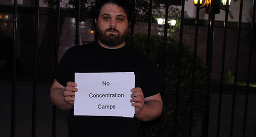 A participant of the action in support of homosexuals in Northern Caucasus with a poster "No Concentration Camps". Photo by Inna Kukudzhanova for "Caucasian Knot" A participant of the action in support of homosexuals in Northern Caucasus with a poster "No Concentration Camps". Photo by Inna Kukudzhanova for "Caucasian Knot"