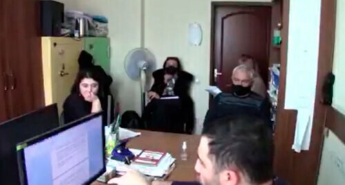 Interrogation of Zarina Dzagoeva (far left). Screenshot: http://youtu.be/D3LDhcQQAS8