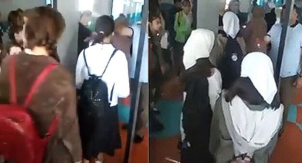 Schoolgirls entering a school. Collage made by the Caucasian Knot. Screenshot: http://youtu.be/I0ctRpYejR8/ Schoolgirls entering a school. Collage made by the Caucasian Knot. Screenshot: http://youtu.be/I0ctRpYejR8/