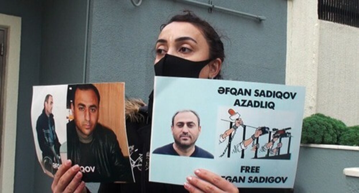 Sevindj Sadygova, the wife of Afghan Sadygov, holds the portraits of her husband at a protest action. Baku, February 9, 2021. Photo by Parvana Bayramova for the "Caucasian Knot" Sevindj Sadygova, the wife of Afghan Sadygov, holds the portraits of her husband at a protest action. Baku, February 9, 2021. Photo by Parvana Bayramova for the "Caucasian Knot"