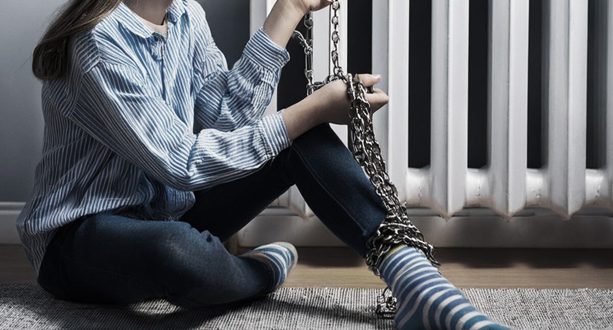 A girl chained to a heat radiator. Picture made in Photoshop by the "Caucasian Knot"