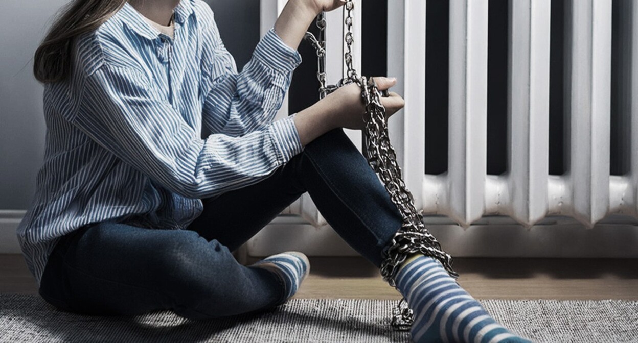 A girl chained to a heat radiator. Picture made in Photoshop by the "Caucasian Knot"