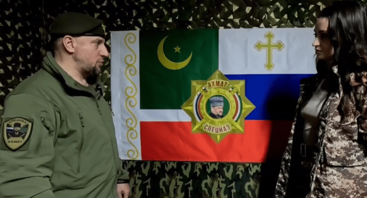 Apti Alaudinov tells a journalist about the “Akhmat” special forces battalion’s flag. A screenshot from the video posted by Anastasia Babir in her Telegram channel on May 23, 2025, https://t.me/SovaBabir/217. Apti Alaudinov tells a journalist about the “Akhmat” special forces battalion’s flag. A screenshot from the video posted by Anastasia Babir in her Telegram channel on May 23, 2025, https://t.me/SovaBabir/217.