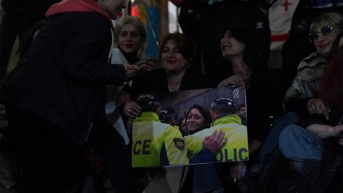 Protesters outside parliament hold a photo of Elene Khoshtaria. Photo: Khatia Kakhidze / Publika