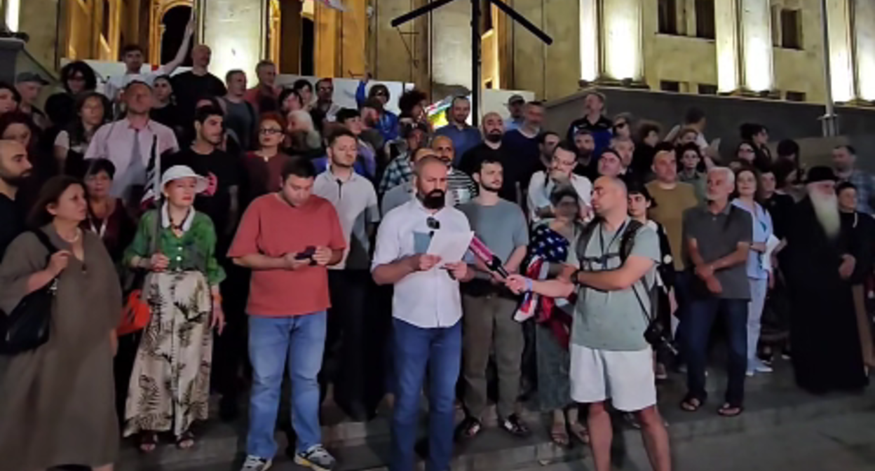 Activists read an address to the EU. A still from a video by Publika from 05.07.26, https://www.facebook.com/reel/970950939308170.