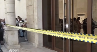 Employees of "Multi Tobacco" at the sealed entrance to the enterprise, July 14, 2026. Frame from video Yerevan Today / YouTube