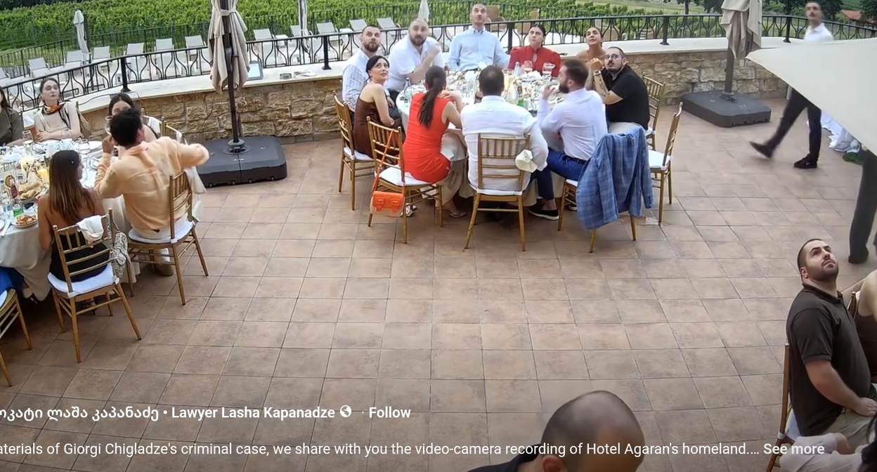 Wedding participants look up after the shouts from the balcony. Screenshot from Lasha Kapanadze's publication.